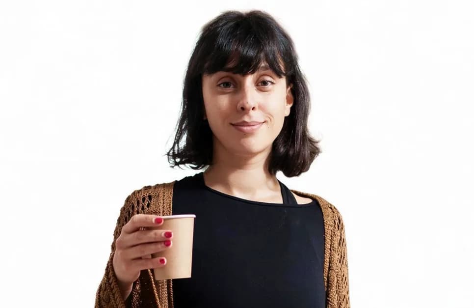 Founder of Ledger holding a clipboard and a coffee